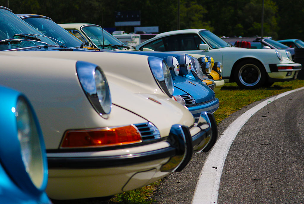 Row of classic Porsche front ends on track at Lime Rock Park, CT